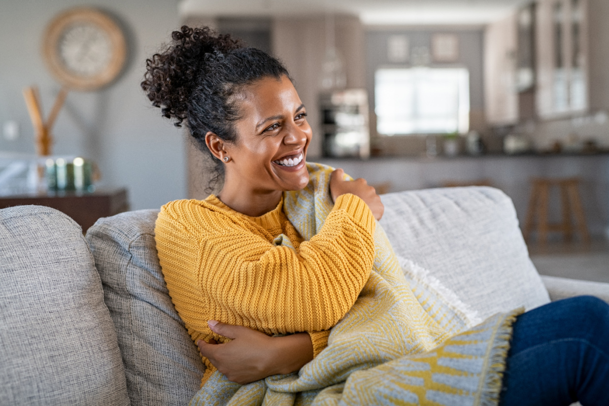 black woman with blanket on couch