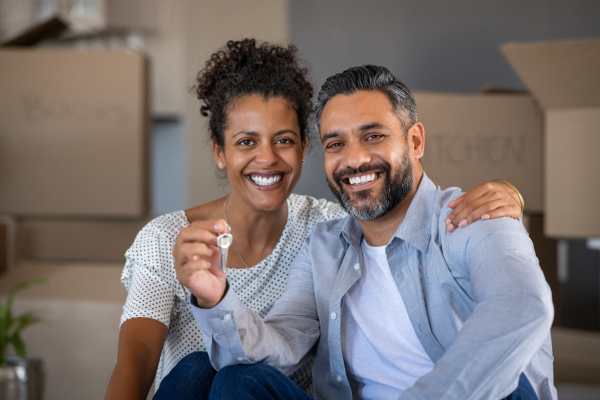 Black couple holding house keys