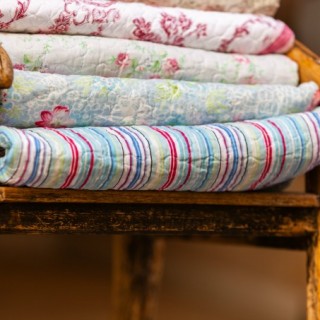 quilts in a rustic chair