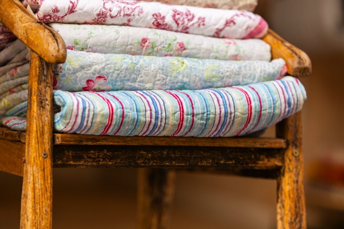 quilts in a rustic chair