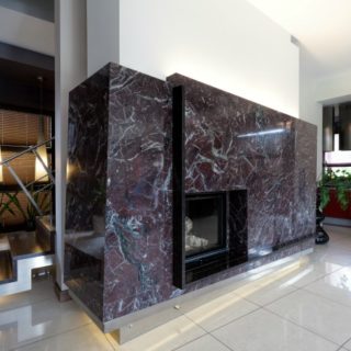 Modern fireplace covered with black marble