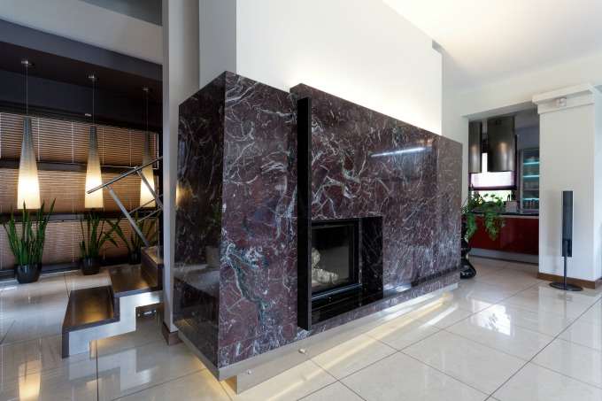 Modern fireplace covered with black marble