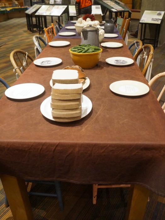 A table set how it would be in the late 1800s. All food items are made from fabric sculpture.