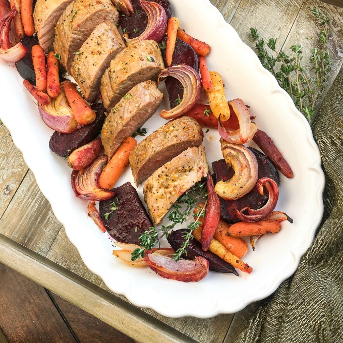 Pork roast with orange glaze carrots beets and onions