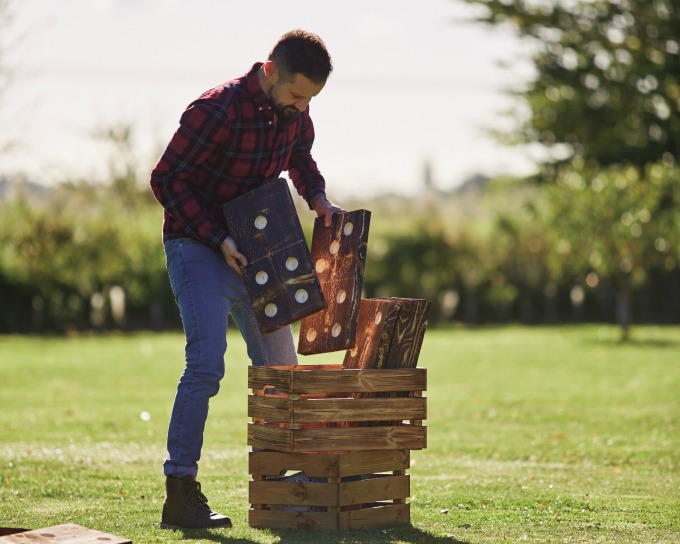 Man with giant outdoor yard dominoes
