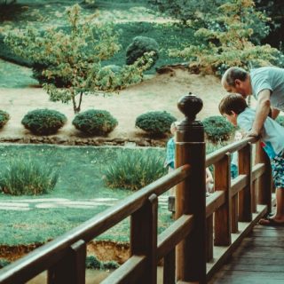 Man and boy looking over a bridge