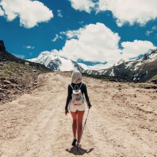 Woman walking in shorts on a dirt path