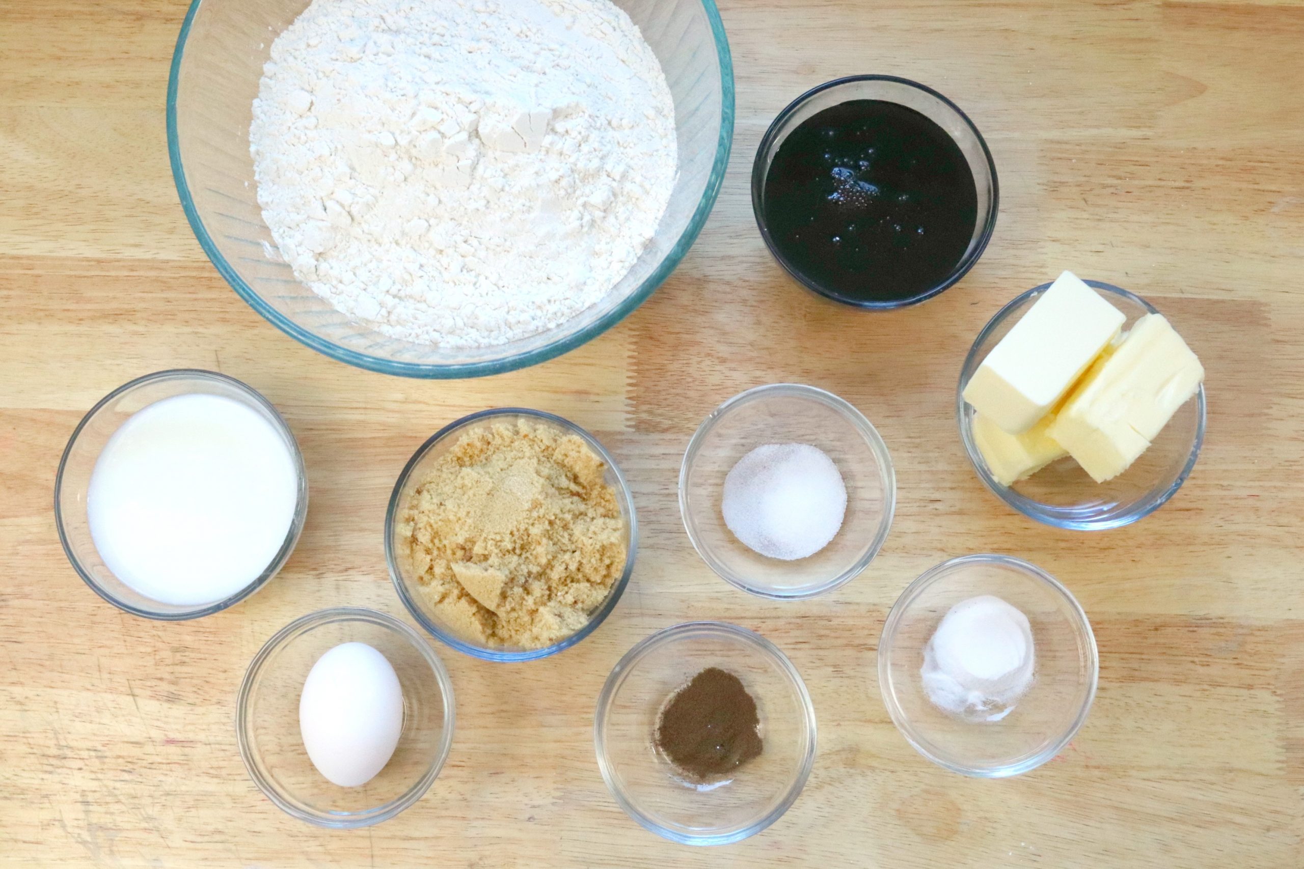 ingredients for Whoopie Pies in clear glass bowls sitting on a wooden table