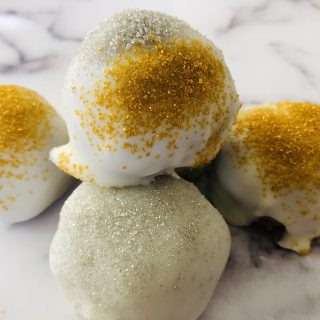 4 gingersnap cookie balls sitting on a marbled table