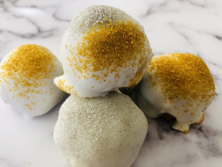 4 gingersnap cookie balls sitting on a marbled table