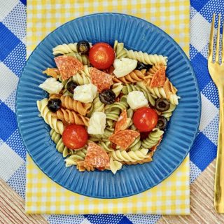 a blue plate filled with pasta salad