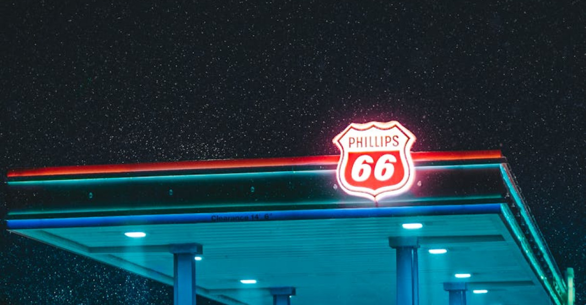 A vibrant neon-lit gas station amidst a snowy landscape at night