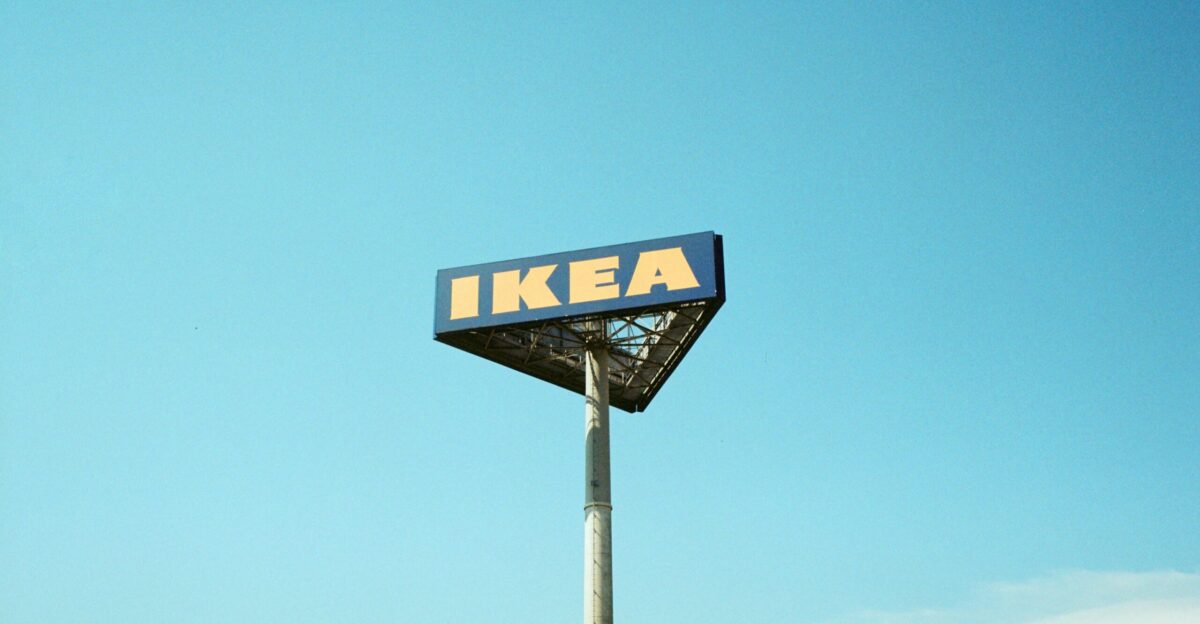 a ikea sign on a pole against a blue sky