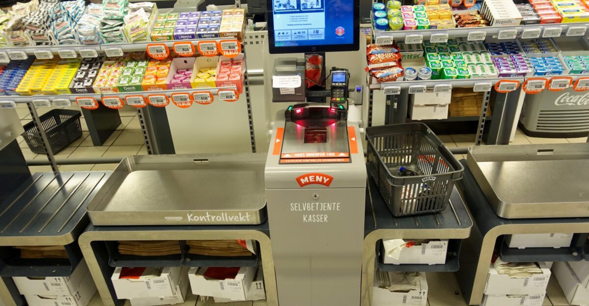 Self-service check-out i e self-checkout with barcode scanning and payment machine selvbetjent kasse med vareskanning og betalingsautomat for customers at a grocery store supermarket in Norway Also supermarket interior etc Meny Supermarket in Industrivegen in Os municipality in Hordaland county Norway November 28th 2019