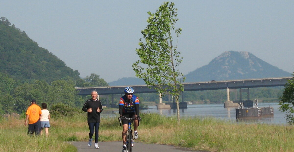 Arkansas River Trail - users enjoying the western portion of the trail with Pinnacle Mountain in the background in central Arkansas
