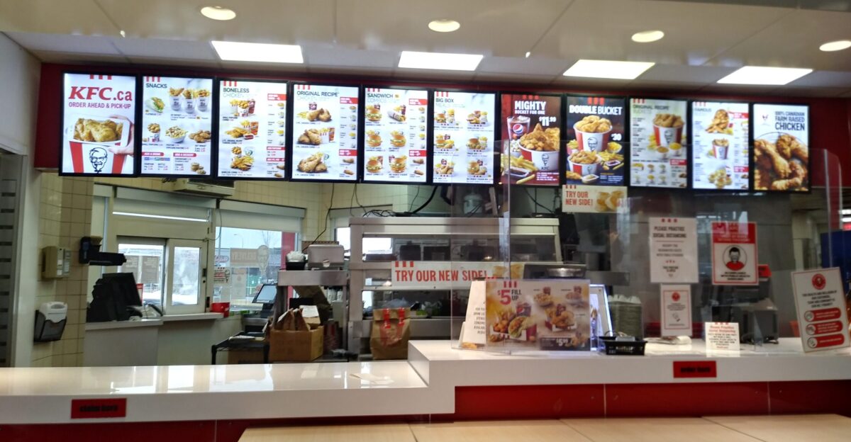 A front counter and menu at a KFC restaurant in Edmonton Alberta Canada in 2020