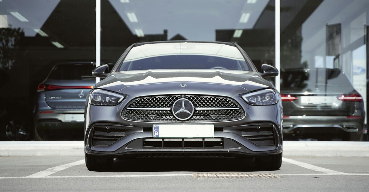 Front view of a sleek gray Mercedes-Benz sports car parked at an auto dealership