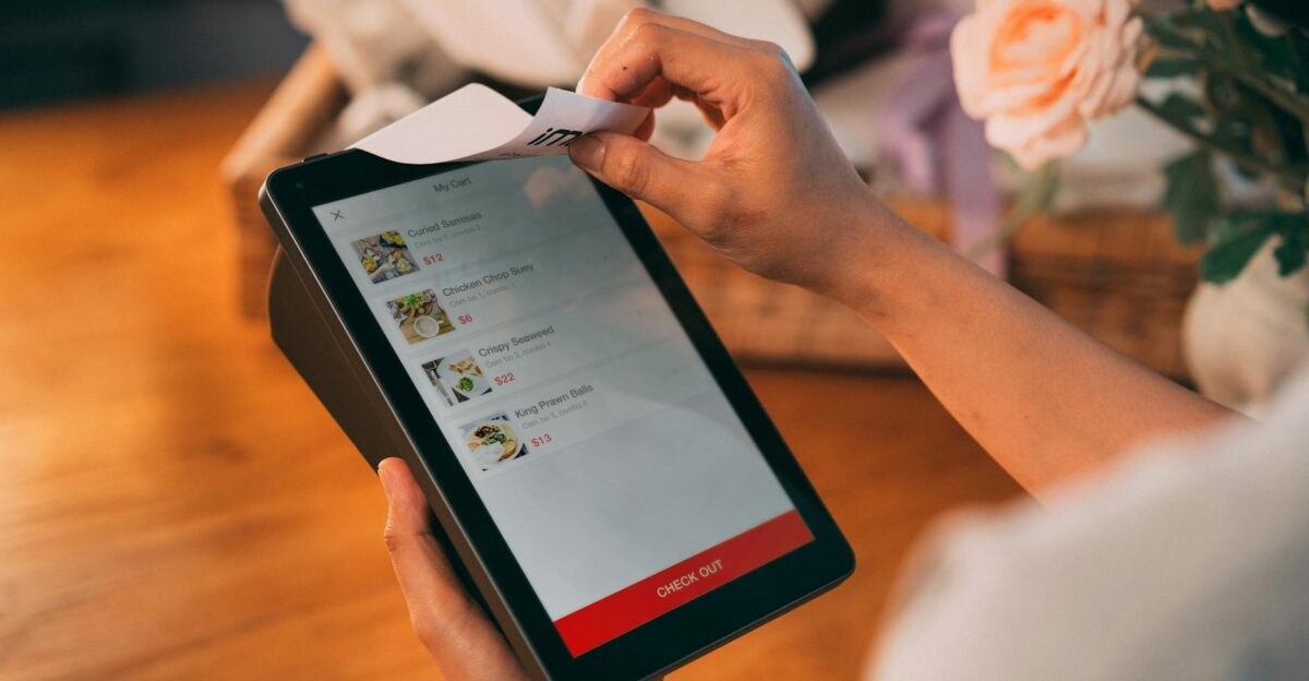 Hands using tablet for cashless payment showcasing modern technology in retail