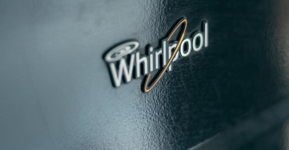 Detailed view of Whirlpool logo on metallic kitchen appliance surface