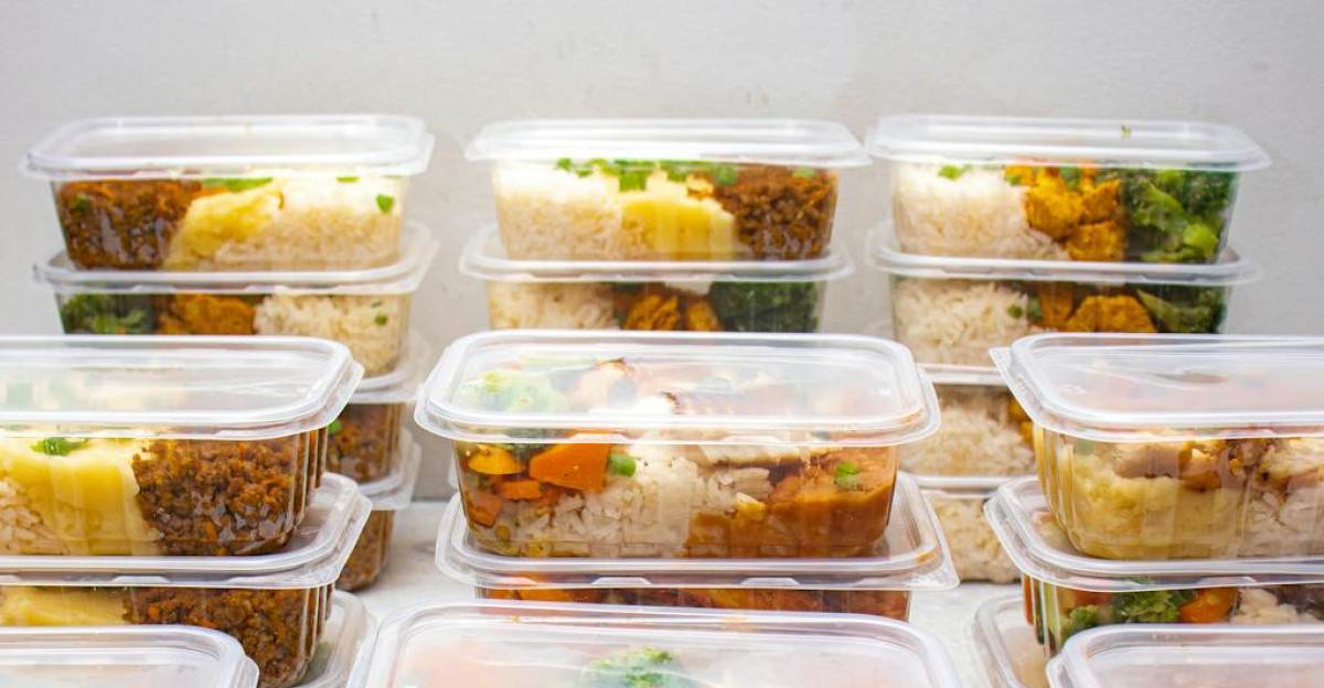 Organized meal prep containers filled with rice and vegetables for healthy eating