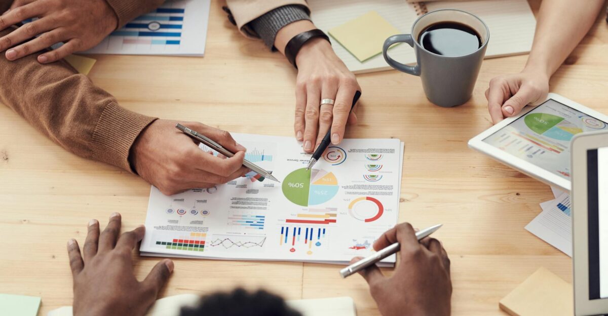 Colleagues discussing data and strategy in an office meeting