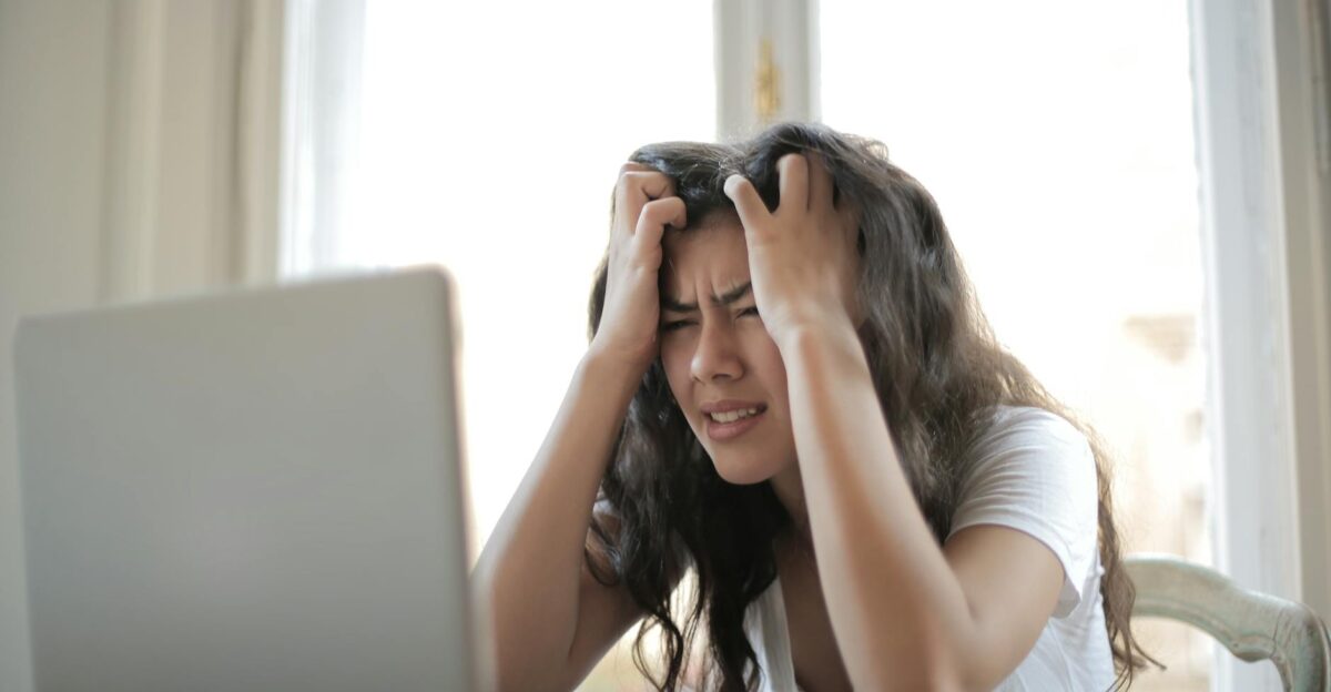Frustrated woman struggling with remote work stress and digital challenges indoors