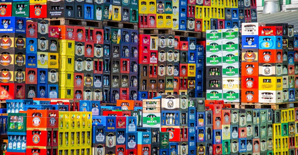 A vibrant display of beer crates stacked in a warehouse showcasing various brands