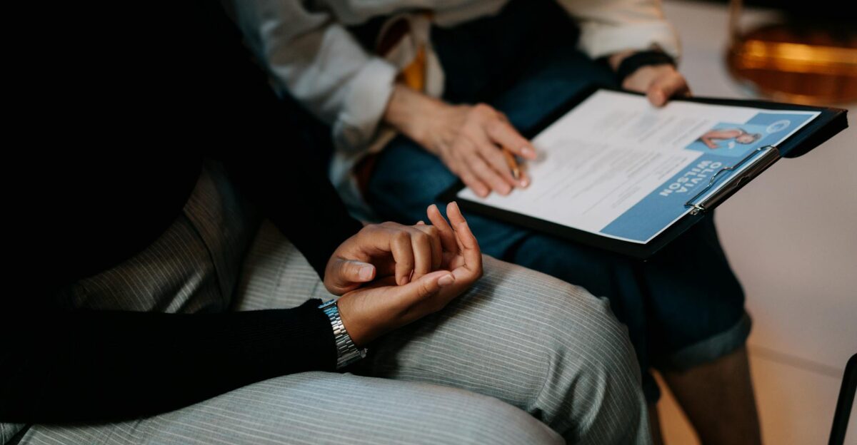 Two professionals reviewing a resume in an office setting focused on teamwork