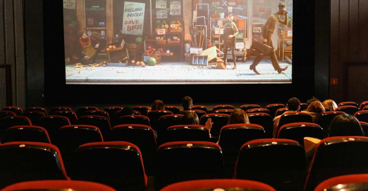 A cozy indoor movie theater showing an animated film to a small audience