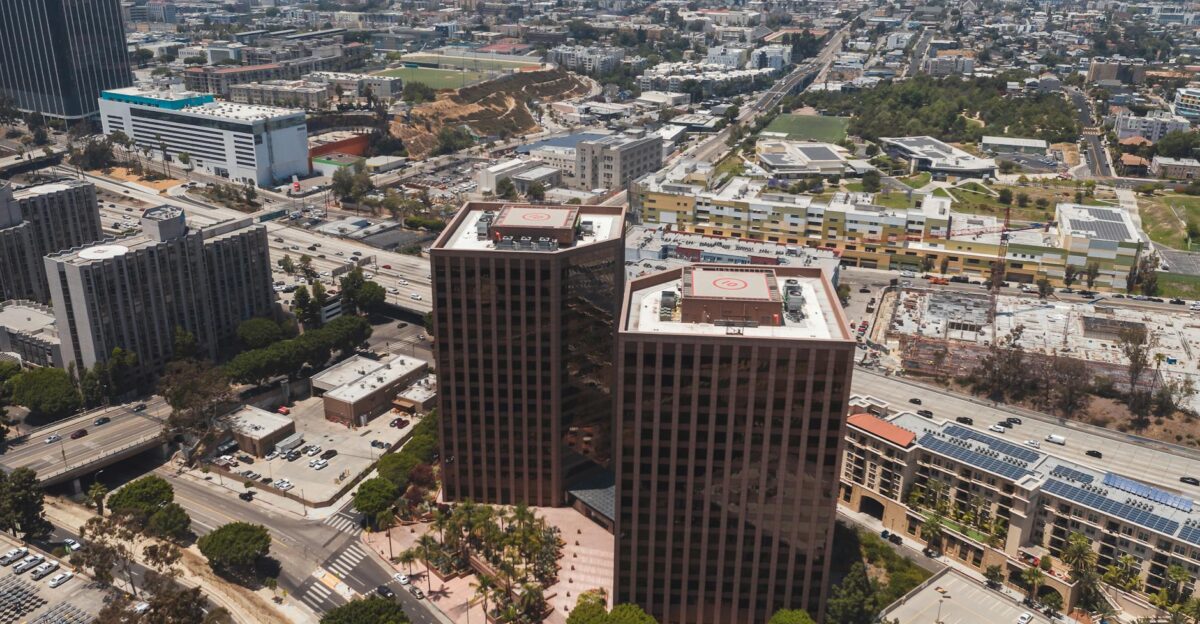 Drone shot capturing modern buildings in a bustling cityscape perfect for urban visuals