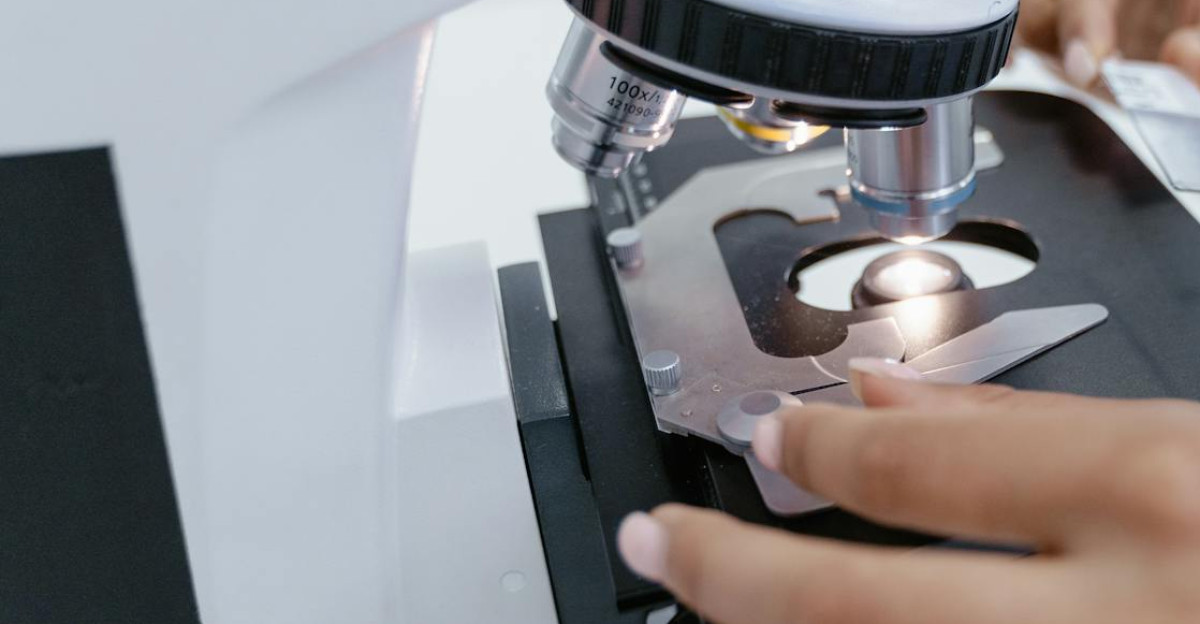 Scientist in laboratory using a microscope for detailed sample analysis