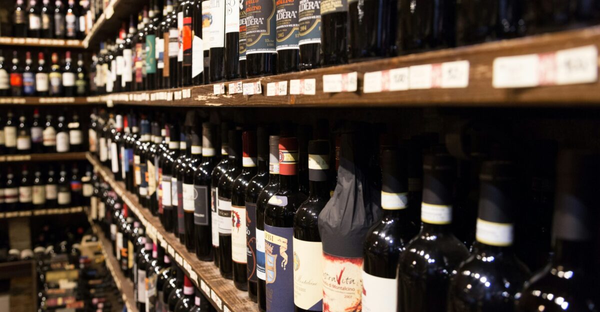 assorted wine bottle lot displaying on rack