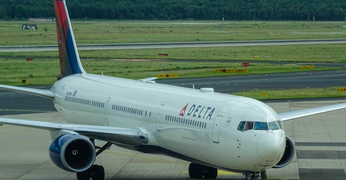 white Delta airplane on airport