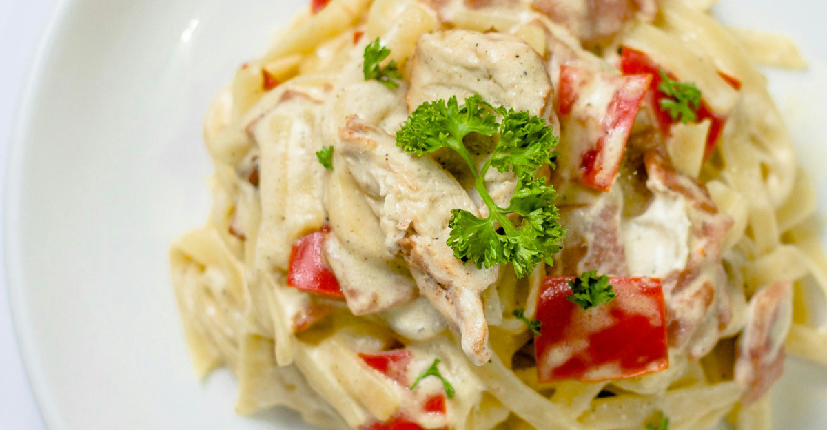plate of white pasta with red bell pepper