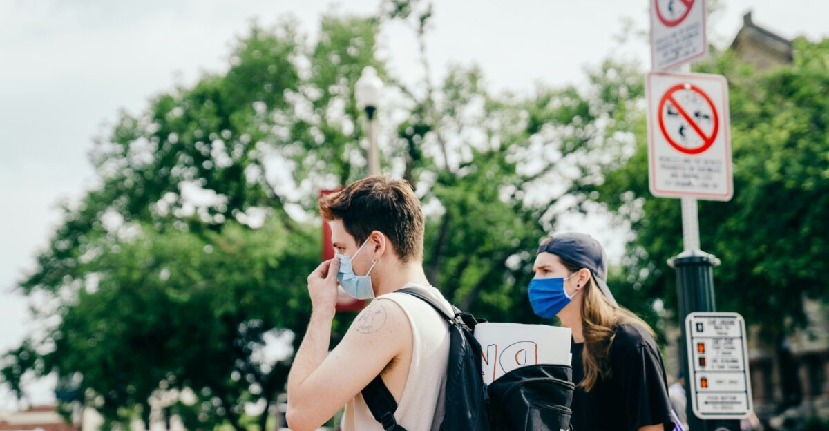 woman in white tank top standing beside man in black shirt