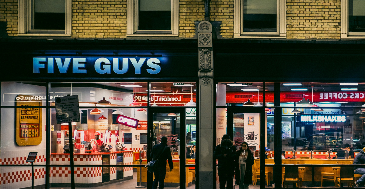 people walking on sidewalk near store during daytime