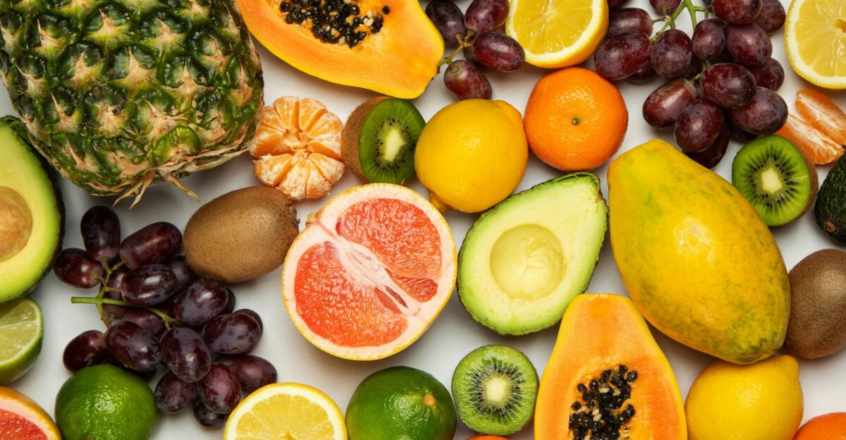 sliced orange fruit and green round fruits