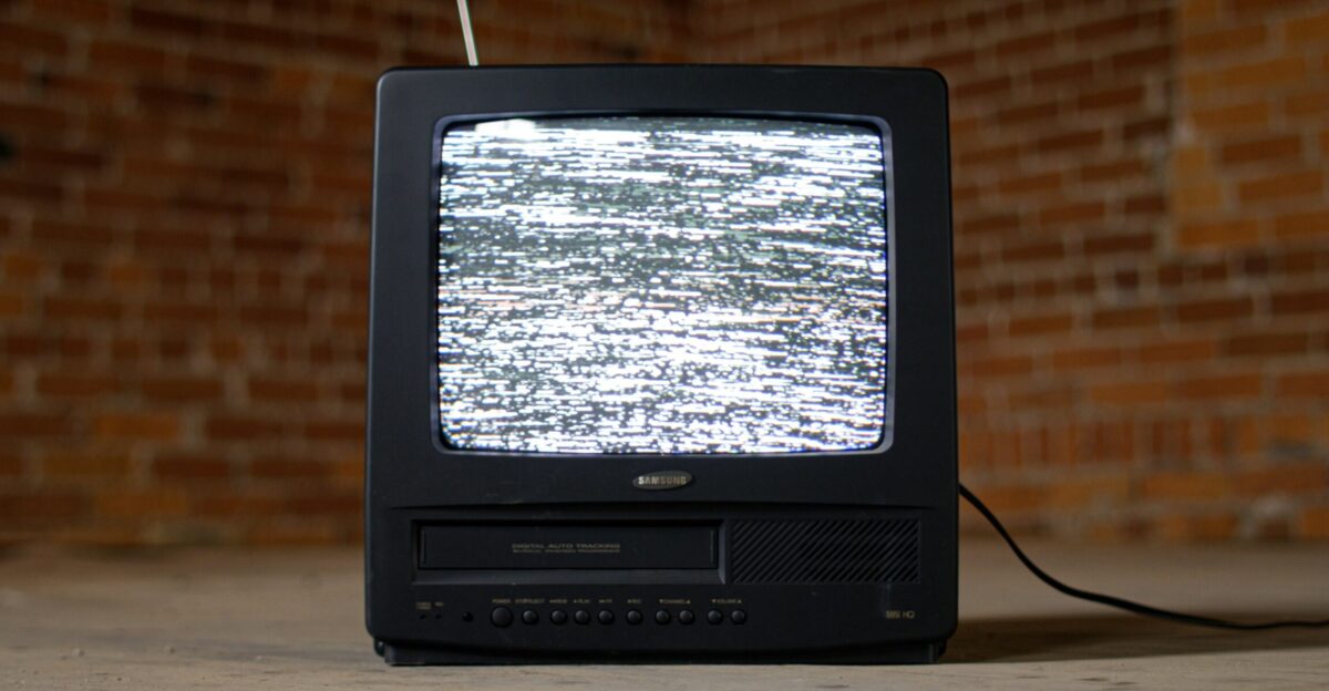 black crt tv on brown wooden table