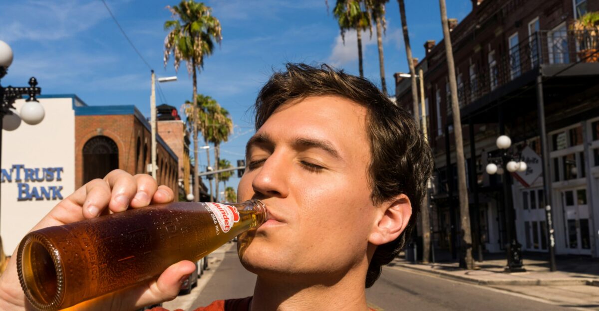 man in red crew neck shirt drinking beer