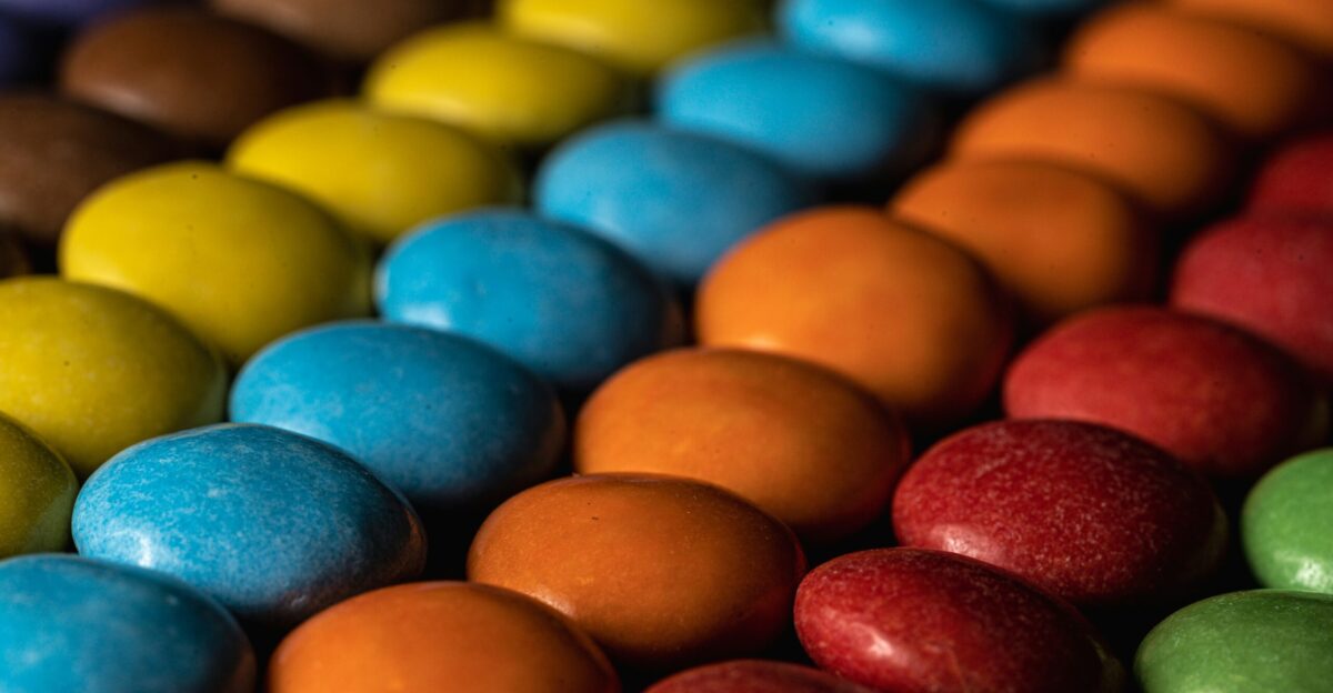 a close up of a row of colored candies