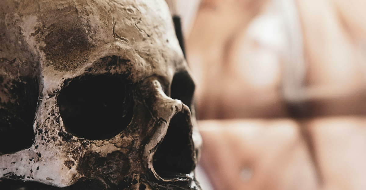 a human skull with headphones hanging on a wall