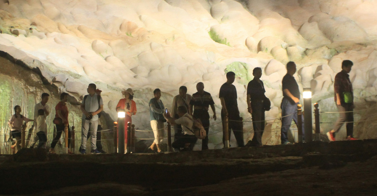a group of people standing in a cave