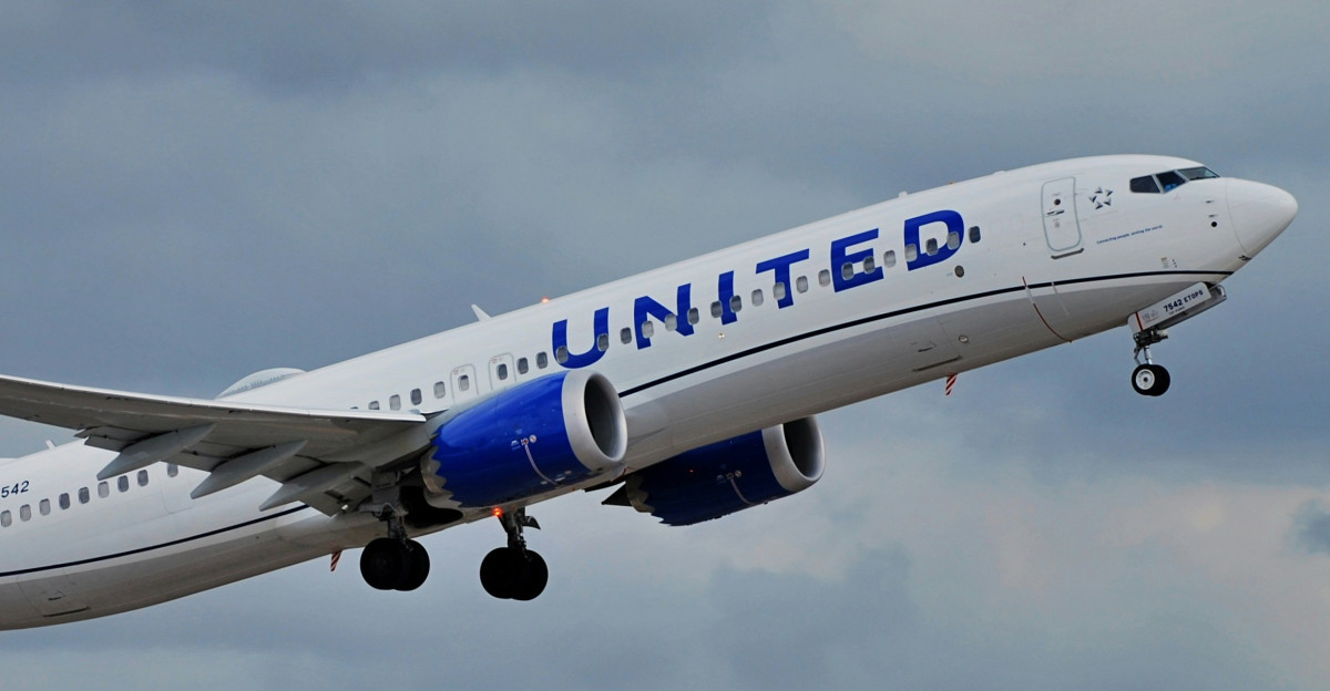a large jetliner flying through a cloudy sky