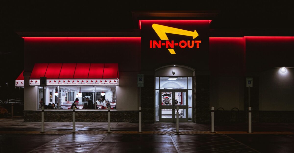 an in - n - out store lit up at night