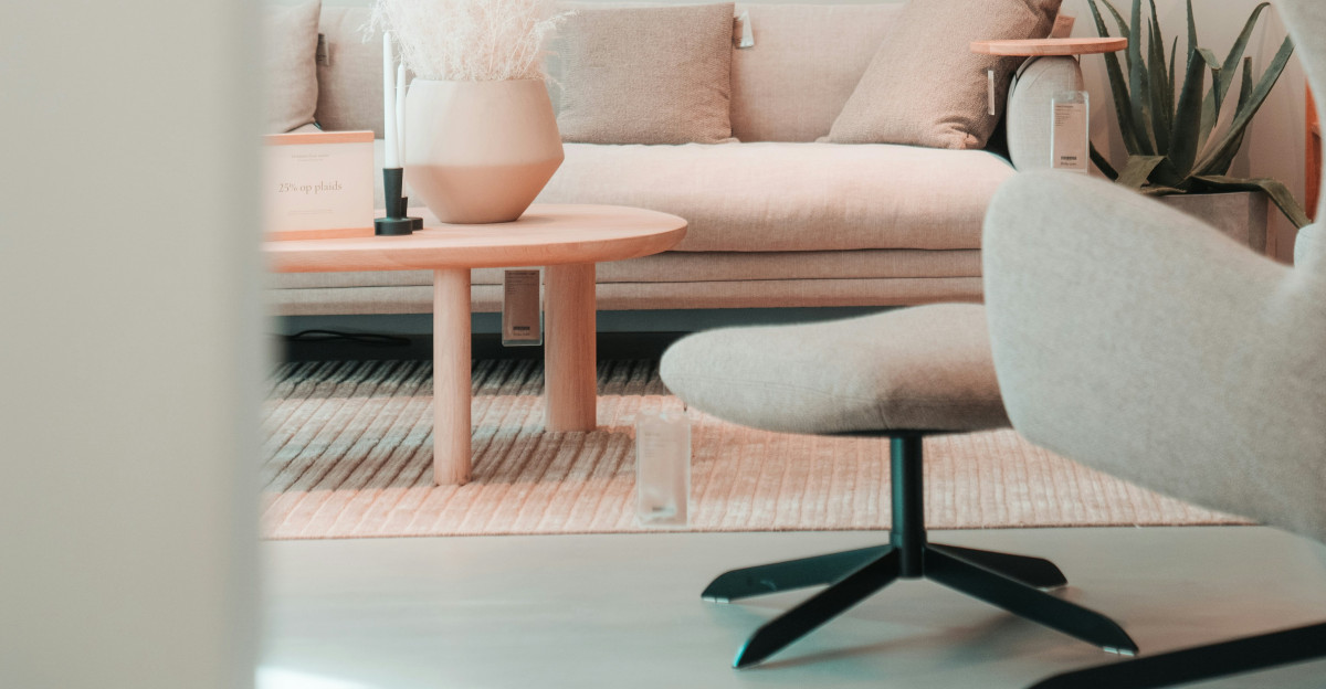 a living room with a couch chair and a table