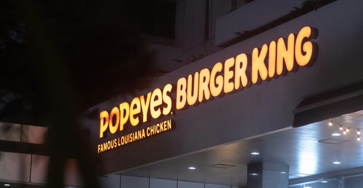 a burger king sign is lit up at night