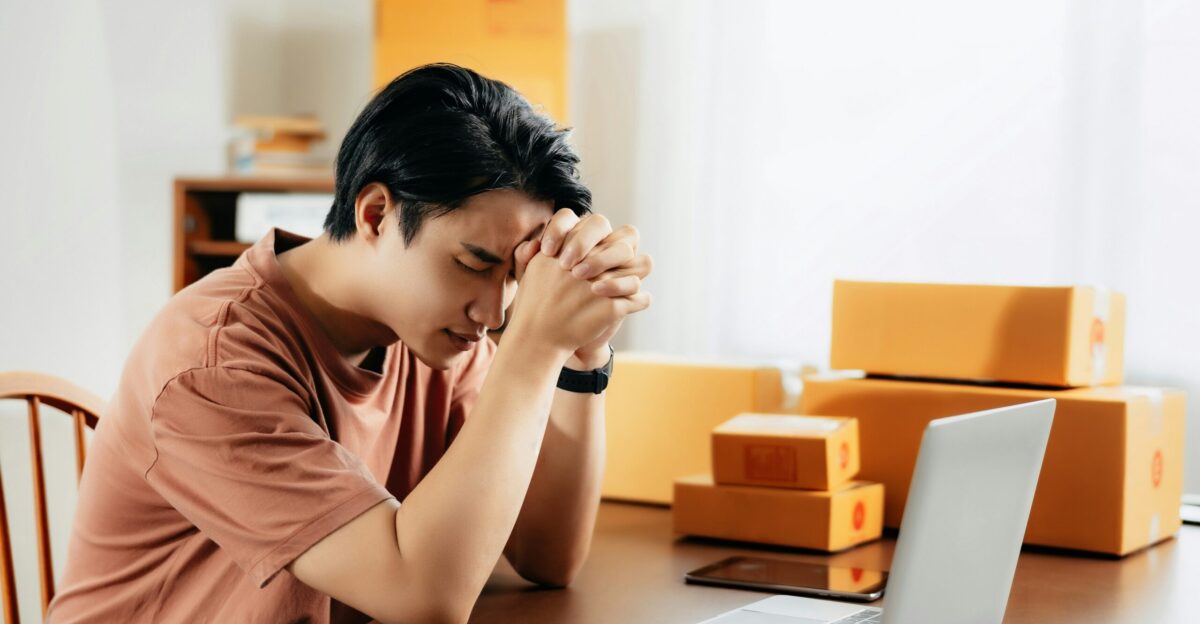 a man sitting in front of a laptop computer