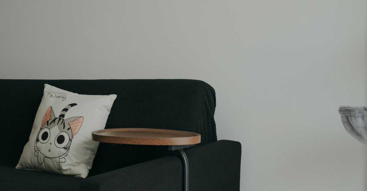 a black couch with a wooden table on top of it