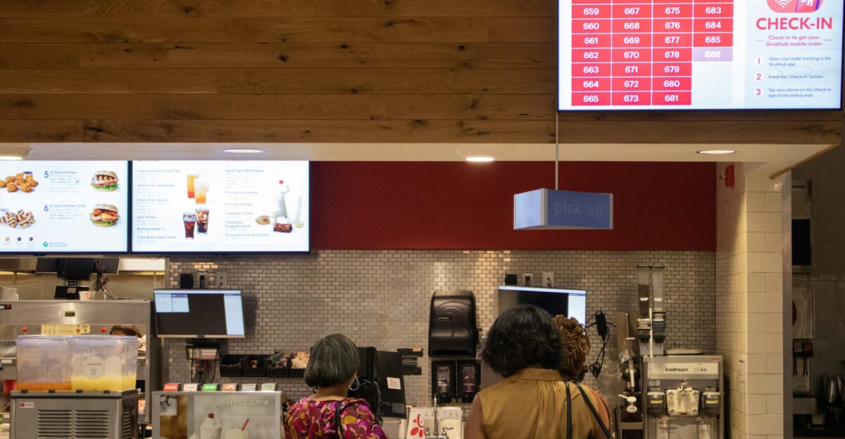 a couple of women standing in front of a counter