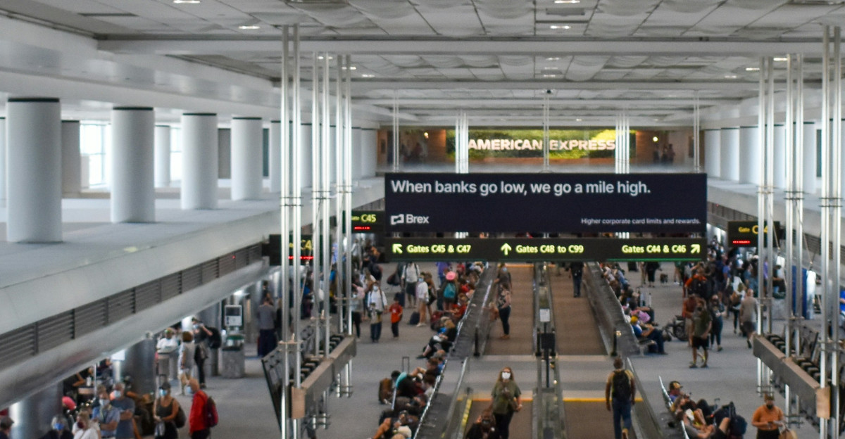 A group of people walking through an airport